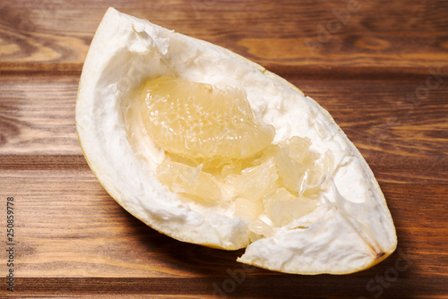 peeled citrus fruit Pomelo on a wooden background photo