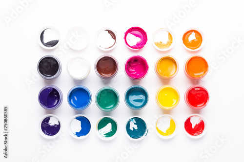 Multicolored gouache on a white background Isolated Paints in containers Top view