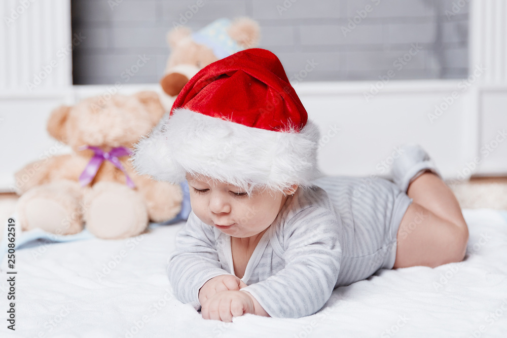 happy baby in Santa's hat on Christmas eve. happy baby in Santa's hat on Christmas eve.
