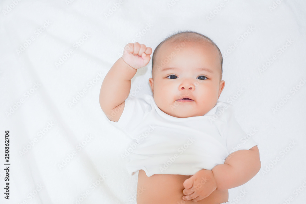 Newborn baby wear half white shirt on white towel background Newborn baby wear half white shirt on white towel background