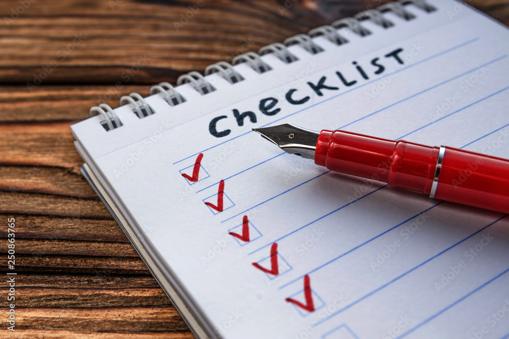 checklist, fountain pen on wooden table background. business planning. checklist, fountain pen on wooden table background. business planning.