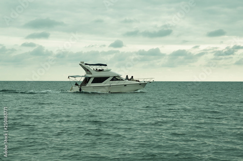 boat in the sea against the cloudy sky. sea travel, entertainment, swimming.