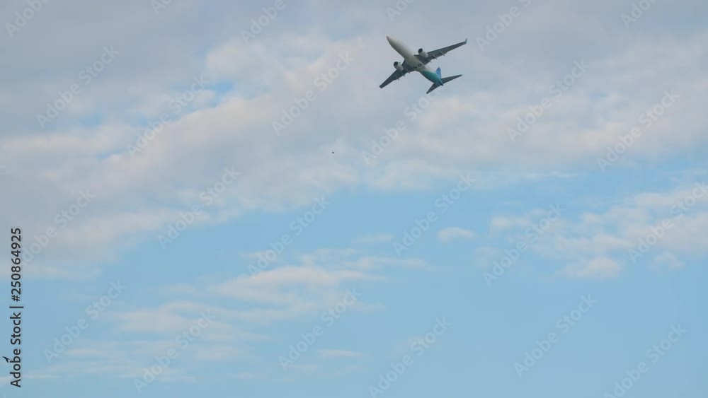 Passenger airplane takes off against the blue sky with clouds. Passenger airplane takes off against the blue sky with clouds.