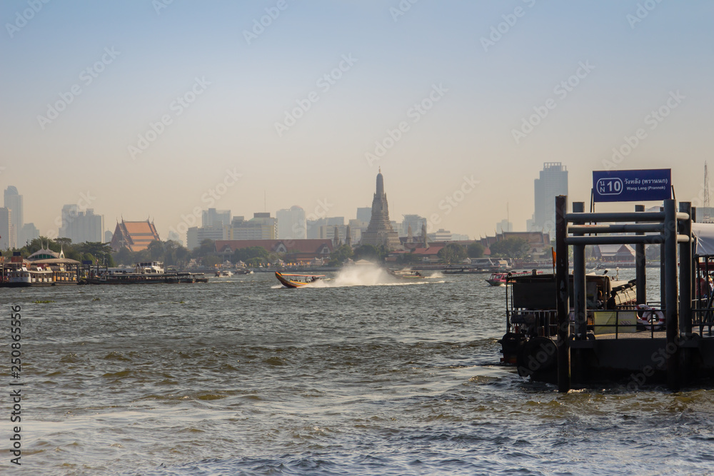 Naklejka premium Waterway traffic in Chao Phraya River. The Chao Phraya Express Boat, a transportation service in Thailand operating on the Chao Phraya River, Bangkok, Thailand.
