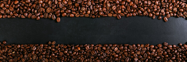 Aroma roasted coffee beans on rustic tabletop, brown banner background.