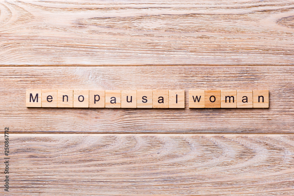 Fototapeta premium menopausal woman word written on wood block. menopausal woman text on wooden table for your desing, concept