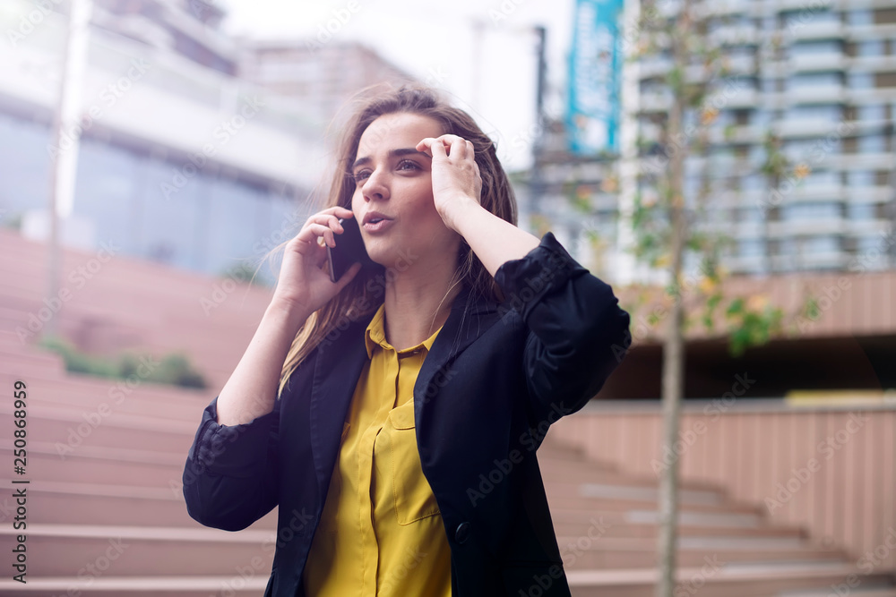 Young business woman uses cellphone at the street Young business woman uses cellphone at the street