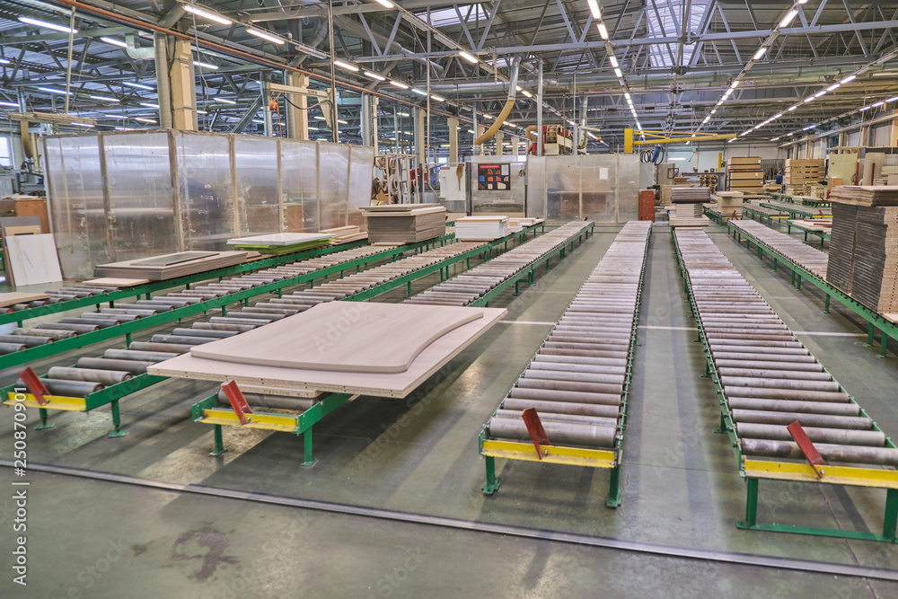 Laying chipboard for processing and production of furniture in a woodworking enterprise.