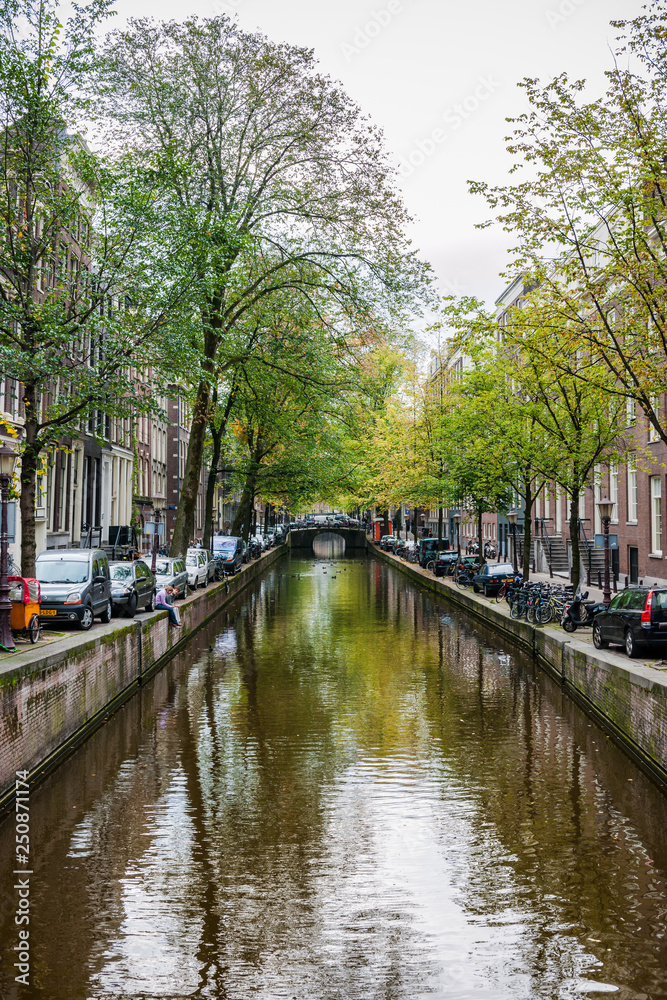 Amsterdam, Netherlands - September 27, 2011: One of the many bridges across Amsterdam canals. Amsterdam has more than 100 kilometres of canals, about 90 islands and 1,500 bridges.
