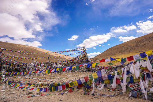 Buddhist prayer flags over the hill and beautiful blue sky in North India.