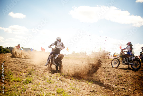 BMX rider kicking up dirt in a race  photo