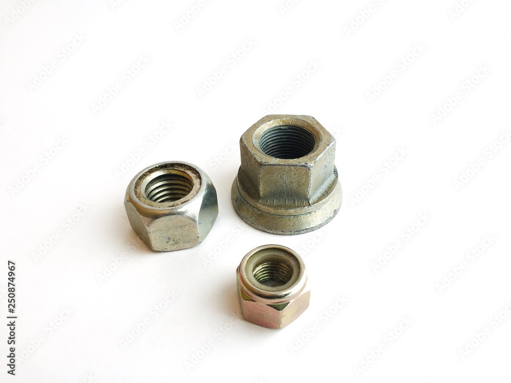 metal hexagon nuts of different sizes on a white background metal hexagon nuts of different sizes on a white background