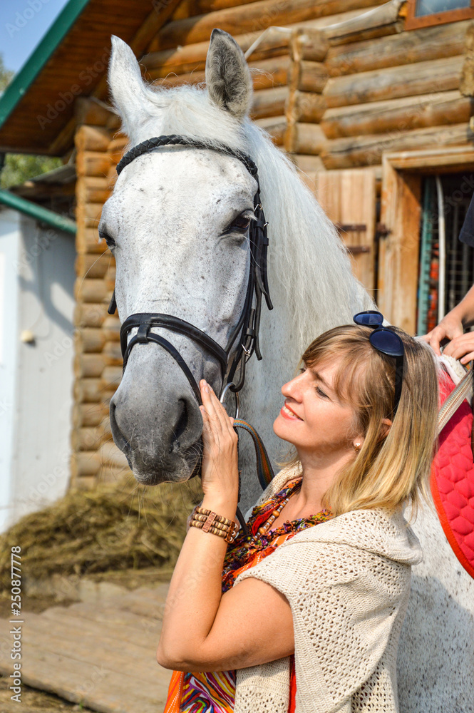 Obraz premium woman with a horse on a farm