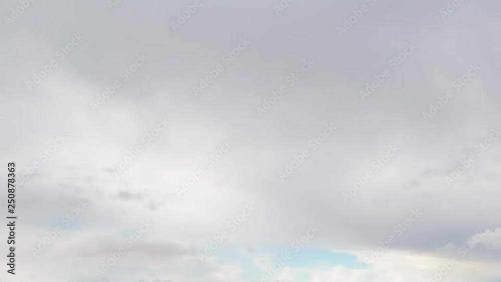 Russia, time lapse. Formation and rapid movement of white clouds of different shapes in the blue sky in late spring at sunset. Russia, time lapse. Formation and rapid movement of white clouds of different shapes in the blue sky in late spring at sunset.
