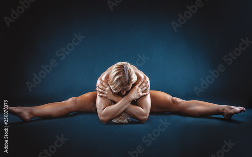 very muscular handsome athletic woman on black background