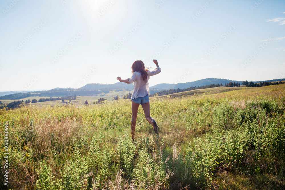 Mid-adult woman walking in field Mid-adult woman walking in field