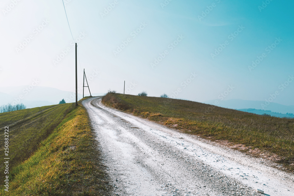 Natural background, landscape with fields and white country road Natural background, landscape with fields and white country road