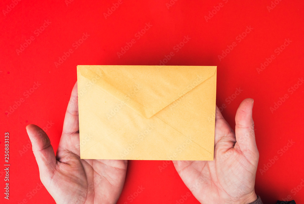 A woman hand hold a envelope and post card on isolated background