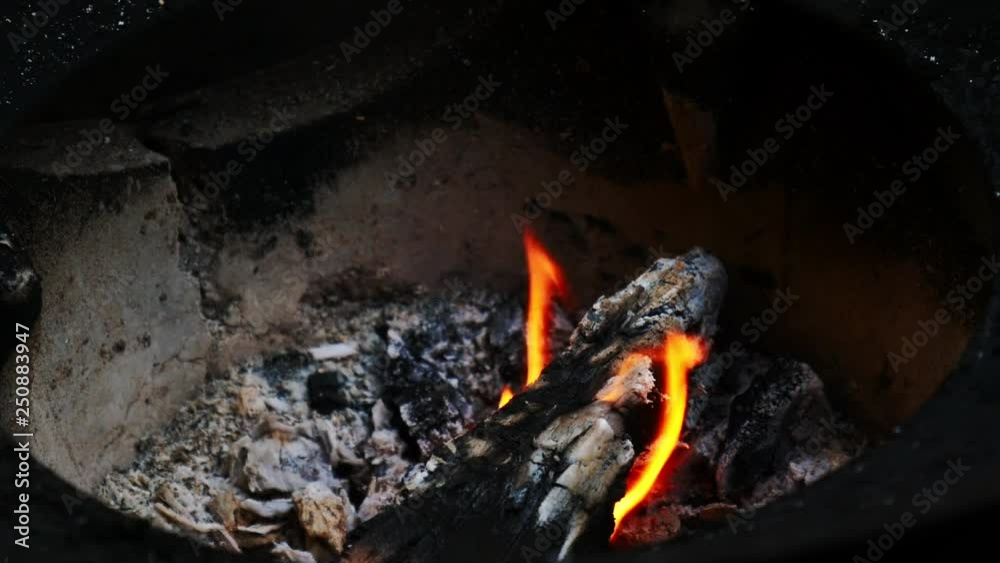 Fire burns firewood in the stove of the villagers before cooking. Fire burns firewood in the stove of the villagers before cooking.