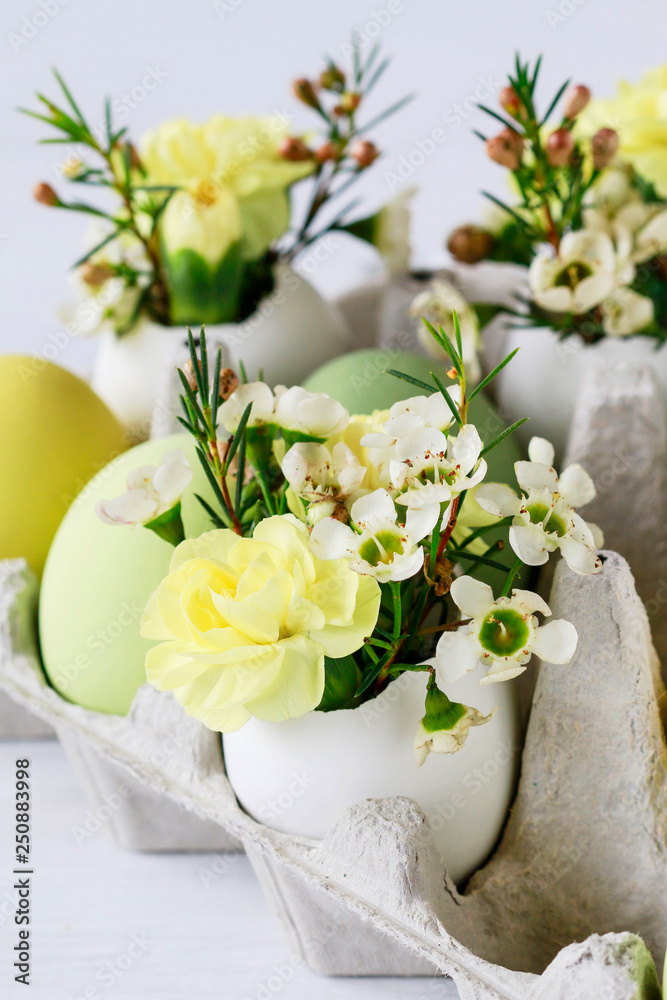 Easter table centerpiece with carnations, wax flowers, moss and eggs Easter table centerpiece with carnations, wax flowers, moss and eggs