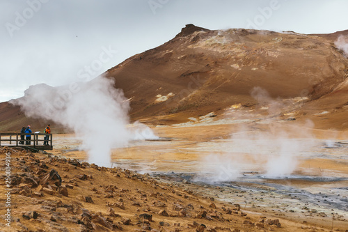 Volcanic landscape of Hverir geothermal area with fumarole field and steam over ground in Iceland on a cloudy summer day