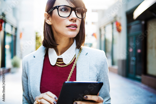 Portrait of woman carrying digital tablet  photo