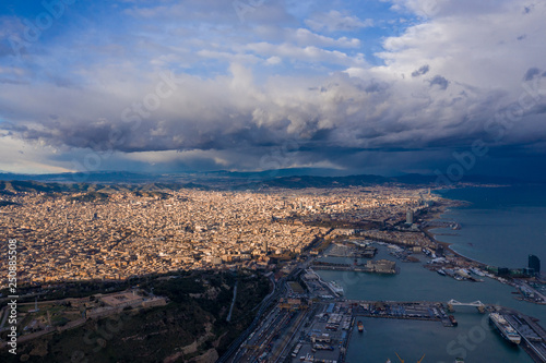 Aerial Barcelona panorama before storm. City with shadows from clouds. Moody weather. Spring in Barcelona Spain