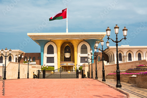 Sultan Qaboos Palace in Muscat with flag in the wind photo