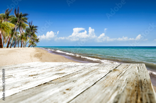 Wooden desk of free space and summer time on beach. 