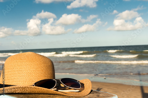 Fototapeta Naklejka Na Ścianę i Meble -  hat and sunglasses on the beach