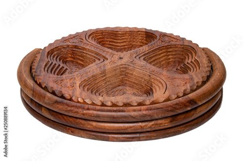 Wooden bowls. Closeup of handmade hinged wooden bowl for fruits, vegetables and nuts isolated on a white background. Decorative souvenir from Malaysia.