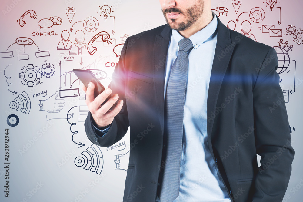 Man with smartphone near business plan sketch Man with smartphone near business plan sketch