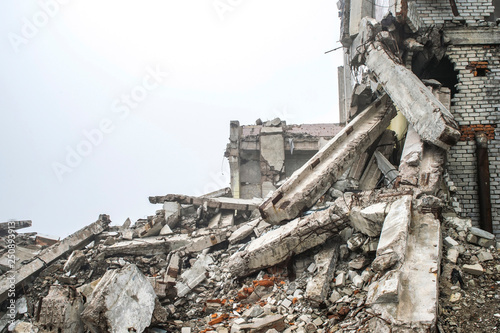 A huge pile of gray concrete debris from piles and stones of the destroyed building. Copy space.