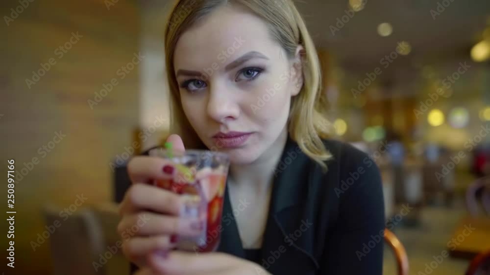 Portrait of a pretty young girl in a cafe drinking warming alcoholic mulled wine Portrait of a pretty young girl in a cafe drinking warming alcoholic mulled wine