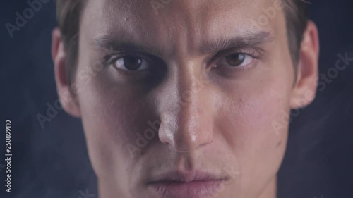 Focused glance. Male looks at camera isolate. Man looks handsome and cool. Guy concentrated focused looking forward. Closeup