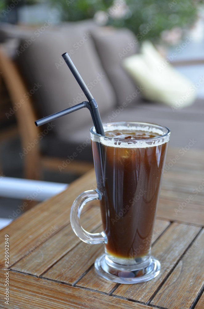 cup of cold coffee on wooden table cup of cold coffee on wooden table