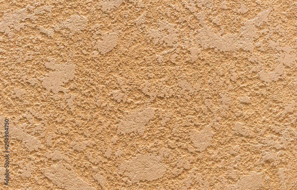 Texture of beige decorative plaster on the wall in the interior of the room. Texture of beige decorative plaster on the wall in the interior of the room.