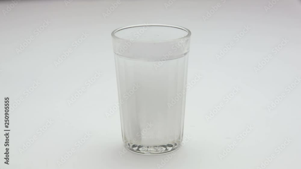 Aspirin or effervescent pill into a glass of water. Aspirin or effervescent pill into a glass of water.