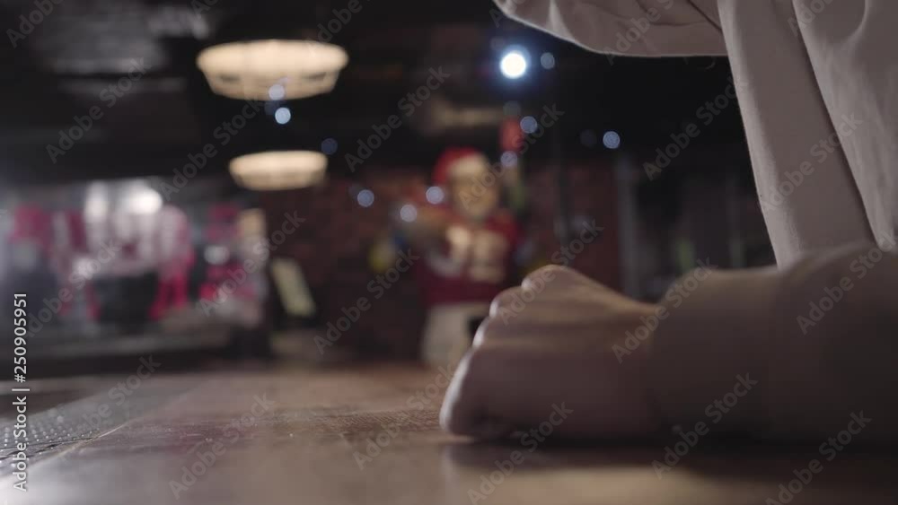 Image of unrecognizable man drinking big glass of beer. Man is angry, he beats his hands on the bar counter. Concept of unhealthy lifestyle, person in condition of alcohol intoxication Image of unrecognizable man drinking big glass of beer. Man is angry, he beats his hands on the bar counter. Concept of unhealthy lifestyle, person in condition of alcohol intoxication