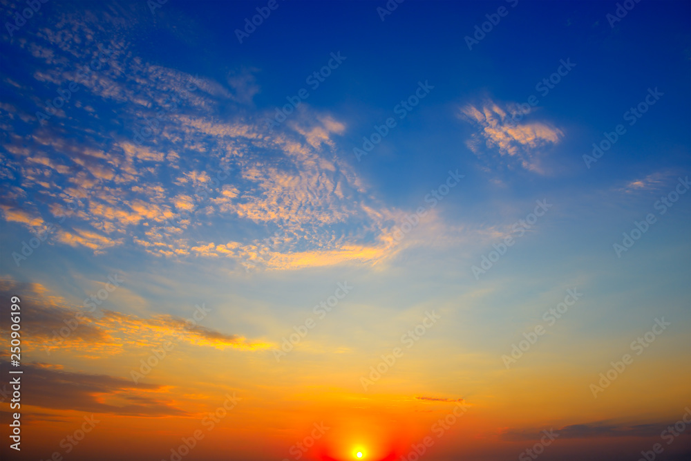 Scenic sunset on background bright blue sky