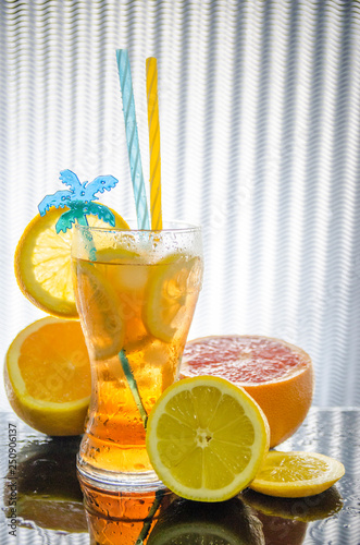 glass of juice with lemon slice of orange