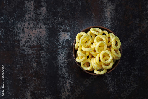 Corn rings in a bowl. Onion rings in a bowl.