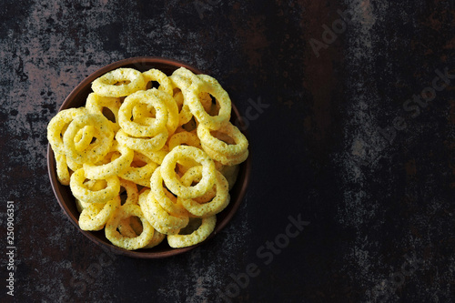 Corn rings in a bowl. Onion rings in a bowl.