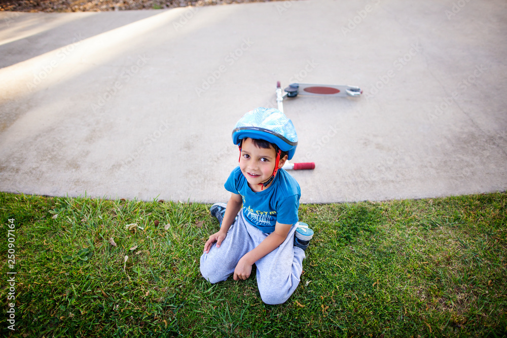 Portrait of boy (4-5) sitting on grass Portrait of boy (4-5) sitting on grass