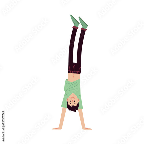 A young smiling brunet man in a tshirt and pants raised his hand up.