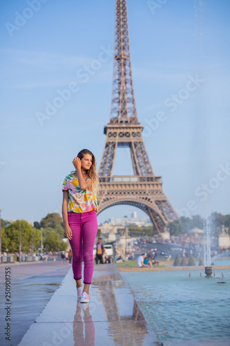 Happy girl walking in centre of Paris. Background of Eiffel tower. Travel concept © Max Topchii