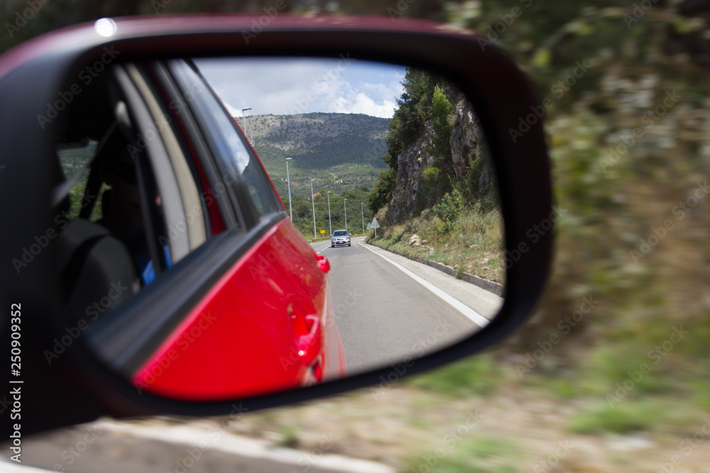 Road in the rear view mirror