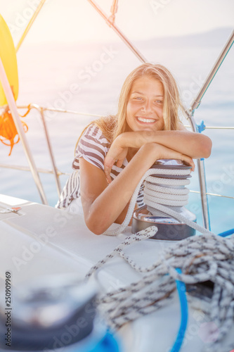 Girl on board of sailing yacht on summer cruise. Travel adventure, yachting with child on family vacation. photo