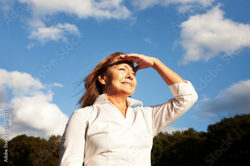 Mature woman looking off into distance Prospect Park, Brooklyn, NY