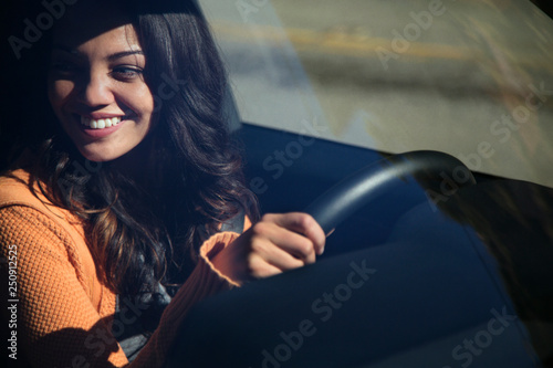 Young smiling woman driving car  photo